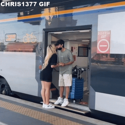 Man And Woman Kissing In Front Of Train Saying Discesa Exit GIF