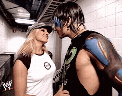 Man And Woman Kissing In Front Of W Logo GIF