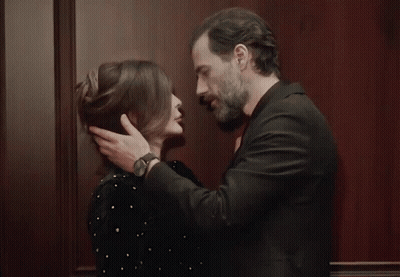 Man And Woman Kissing In Front Of Wall GIF