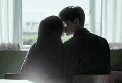 Man And Woman Kissing In Front Of Window GIF