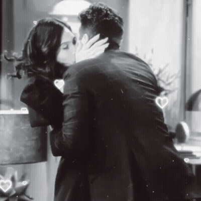 Man and Woman Kissing in Front of Window