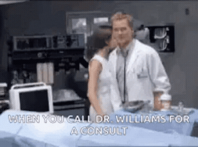 Man And Woman Kissing In Hospital Room While Doctor Listens GIF