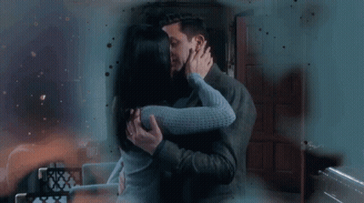 Man And Woman Kissing In Living Room GIF