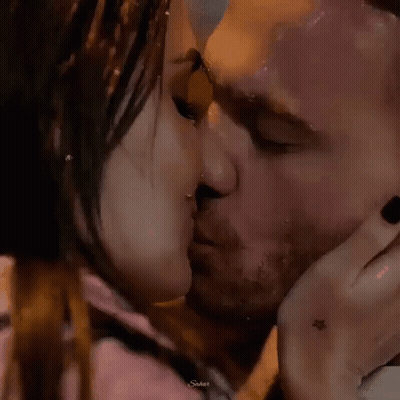 Man And Woman Kissing In Rain GIF