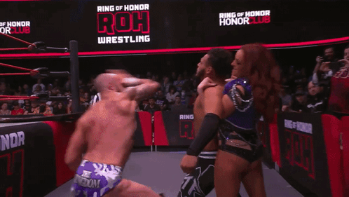 Man And Woman Kissing In Wrestling Ring GIF