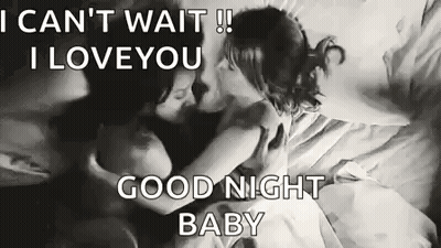 Man And Woman Kissing On A Bed GIF