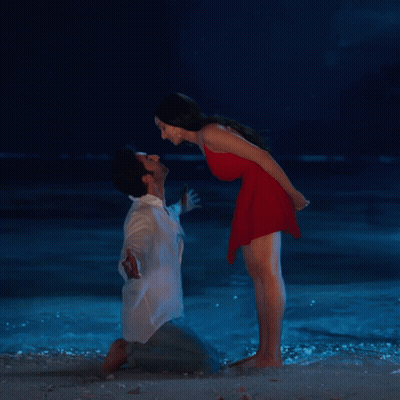 Man And Woman Kissing On Beach At Night GIF