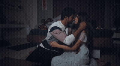 Man And Woman Kissing On Bedroom Floor GIF