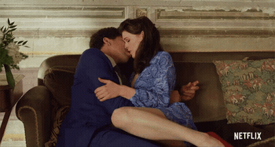 Man And Woman Kissing On Couch With Netflix Logo GIF