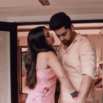 Man And Woman Kissing Under Ceiling Fan GIF
