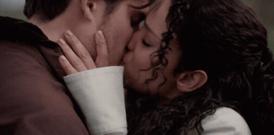Man And Woman Kissing With Hands On Faces GIF