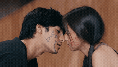 Man And Woman Kissing With Hearts And Stars On Faces GIF