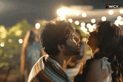 Man And Woman Kissing With Wick Logo GIF