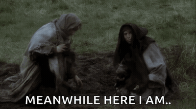 Man And Woman Kneeling In Grass Saying Meanwhile Here I Am GIF