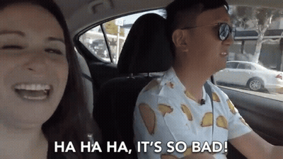 Man And Woman Laughing In Car With Tacos Shirt GIF