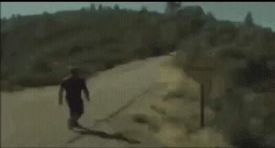 Man And Woman Laughing On Orange Couch GIF