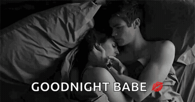 Man And Woman Laying In Bed Hugging And Kissing GIF