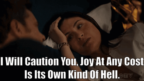 Man And Woman Laying In Bed With Caption I Will Caution You Joy At Any Cost GIF