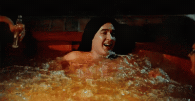 Man And Woman Laying In Hot Tub At Night GIF