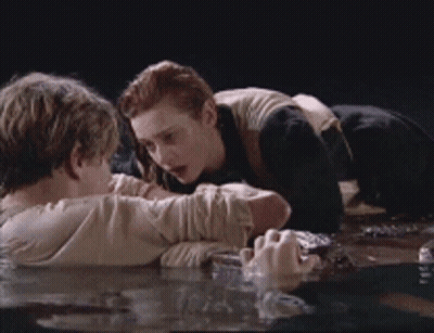 Man And Woman Laying In Water Looking At Each Other GIF