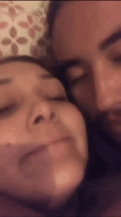 Man And Woman Laying On Bed Making Funny Faces GIF