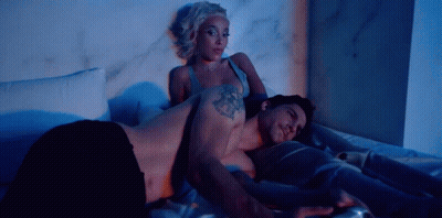 Man And Woman Laying On Bed Man With Arm Tattoo GIF