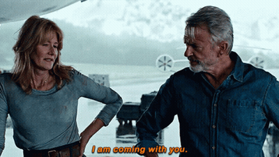 Man And Woman Laying On Bed Pink Shirt Jeans GIF