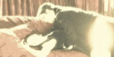 Man And Woman Laying On Bed GIF