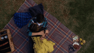 Man And Woman Laying On Blanket GIF