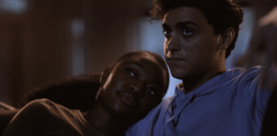 Man And Woman Laying On Couch Taking Selfie GIF