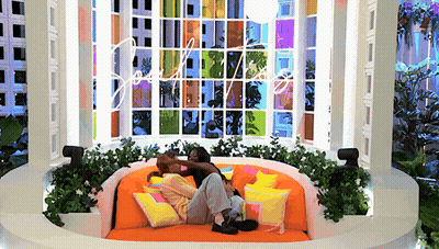 Man And Woman Laying On Round Couch With Love Window GIF