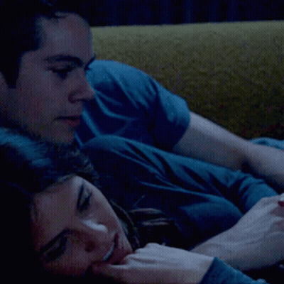 Man and Woman Laying on Yellow Couch