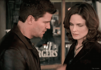 Man And Woman Looking At Each Other By Burgers Sign GIF