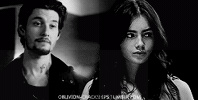 Man And Woman Looking At Each Other In Black And White Photo GIF