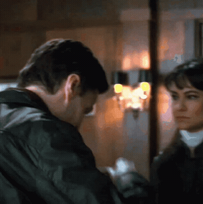Man And Woman Looking At Each Other In Blurry Photo GIF