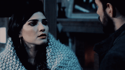 Man And Woman Looking At Each Other In Dark GIF