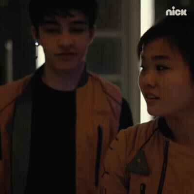 Man And Woman Looking At Each Other In Dark Room GIF