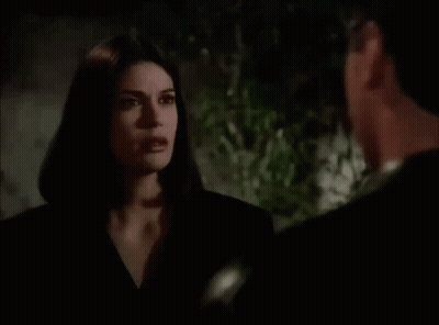 Man And Woman Looking At Each Other In Dark Room GIF
