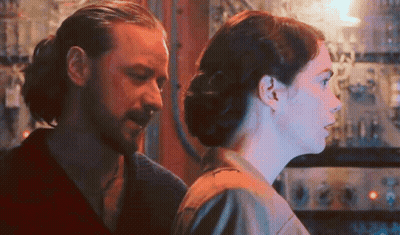Man And Woman Looking At Each Other In Dark Room GIF