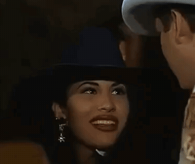 Man And Woman Looking At Each Other In Dark Room, Woman In Cowboy Hat GIF