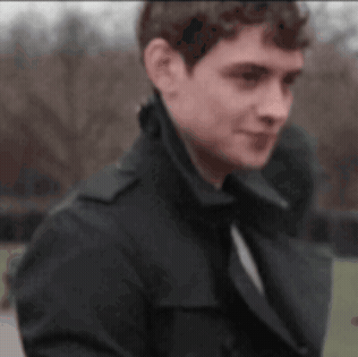 Man And Woman Looking At Each Other In Front Of Waterfall GIF