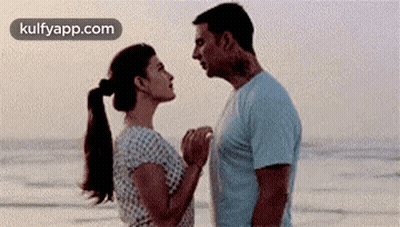Man And Woman Looking At Each Other On Beach GIF