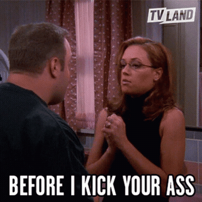 Man And Woman Looking At Each Other Saying Before I Kick Your Ass GIF