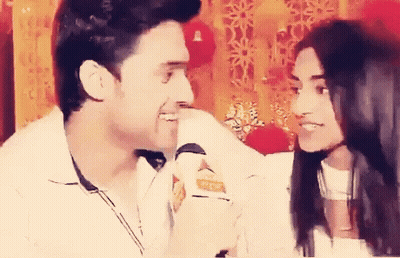 Man And Woman Looking At Each Other Smiling GIF