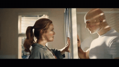 Man And Woman Looking At Each Other Through Window GIF