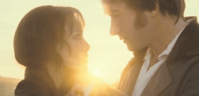 Man And Woman Looking At Each Other With Sun Shining Through Eyes GIF
