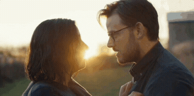 Man And Woman Looking At Each Other With Sun Shining Through Eyes GIF