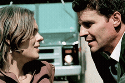 Man And Woman Looking At Each Other With Truck GIF