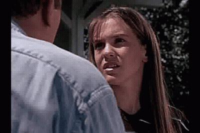 Man And Woman Looking At Each Other, Woman Making Funny Face GIF