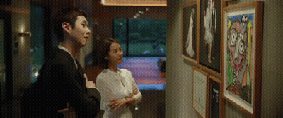 Man And Woman Looking At Painting GIF
